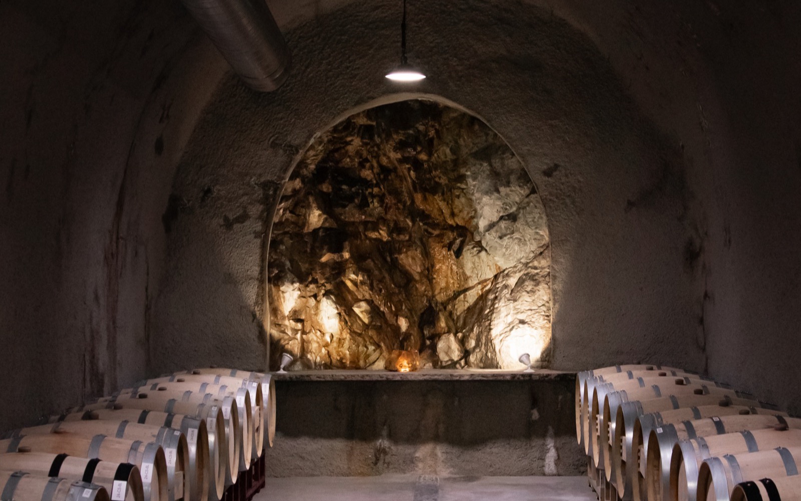 Barrels of Cabernet Sauvignon aging inside the working wine cave at Baldacci Family Vineyards, Stags Leap District, Napa Valley