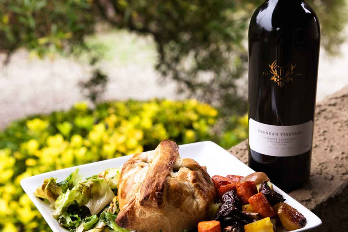 a plate of Beef Wellington with roast vegetables