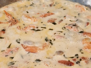 Grilled salmon and prawns in cream sauce