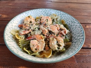 Grilled Salmon and Prawn Pasta Alfredo served