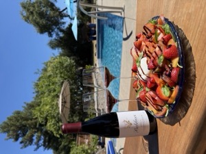 The salad served poolside with a bottle of Elizabeth Pinot Noir and two poured glasses